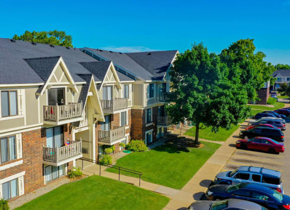 an aerial view of an apartment building with cars parked in front of it at Fairlane Apartments, Springfield, MI, 49037