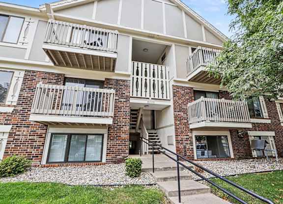 Apartment entrance with stairway and white railings at Fairlane Apartments, Michigan, 49037