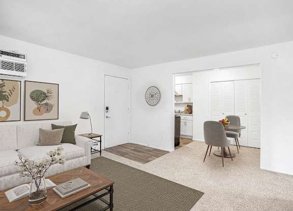 A living and dining room with plush carpeting at Fairlane Apartments, Springfield, Michigan