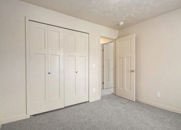 a large bedroom with closet doors at Old Farm Apartments, Elkhart, Indiana