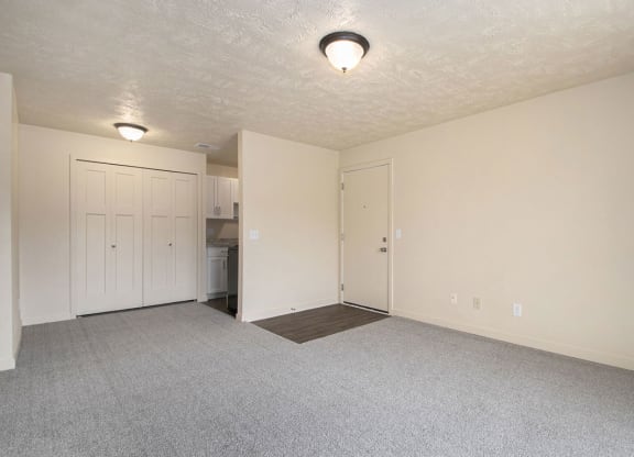 living room and kitchen with plush carpet at Old Farm Apartments, Elkhart, Indiana