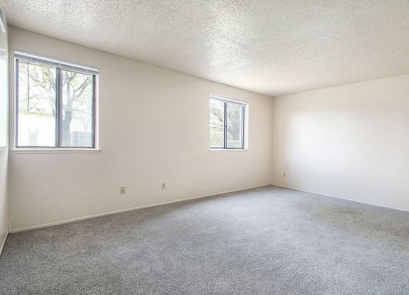 studio living room with two windows at Old Farm Apartments, Elkhart, Indiana