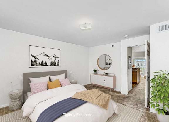 a bedroom with a bed and a mirror in the corner at Fieldstream Apartment Homes, Iowa