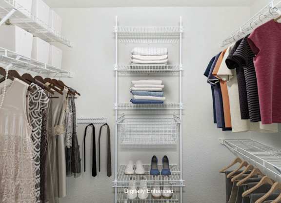 a walk in closet with wardrobe organizers at Fieldstream Apartment Homes, Iowa