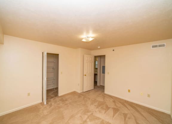bedroom with a walk-in closet with wardrobe organizers at Foxwood and The Hermitage, Portage, MI