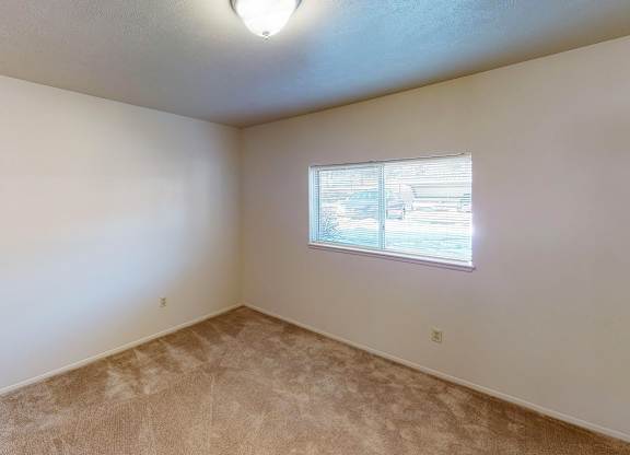 A spacious bedroom with a window at Foxwood and The Hermitage, Portage, MI