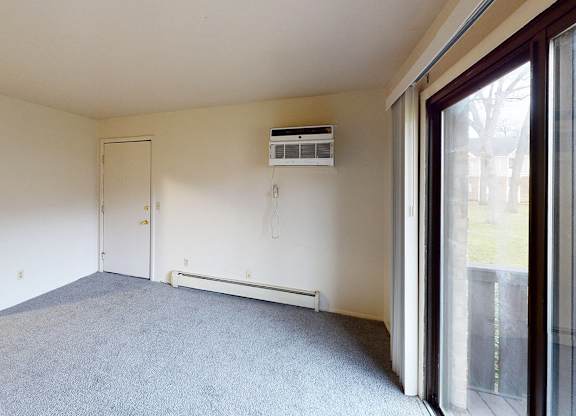 A living room with a carpeted floor at Glen Oaks Apartments, Michigan, 49442
