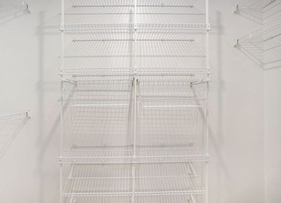 a walk in closet with wardrobe organizers at Glenn Valley Apartments in Battle Creek, MI
