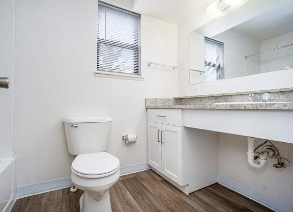 An upgraded bathroom with a window and hard-surface floor at Glenn Valley Apartments, Battle Creek, MI, 49015