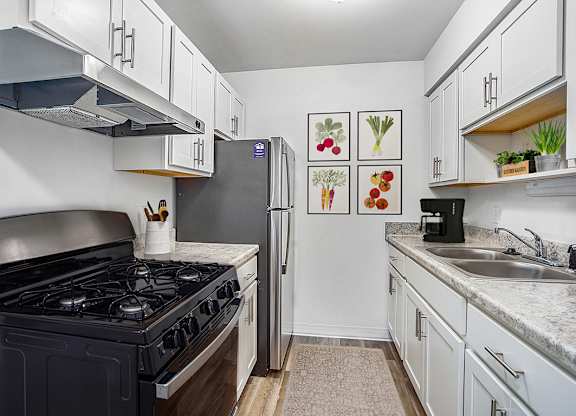 An upgraded kitchen with a gas stove top and a refrigerator at Granada Apartments, Jackson, 49202