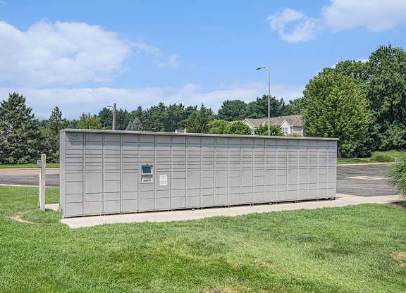 Amazon Hub package lockers surrounded by a grassy area at Gull Prairie/Gull Run Apartments and Townhomes, Kalamazoo