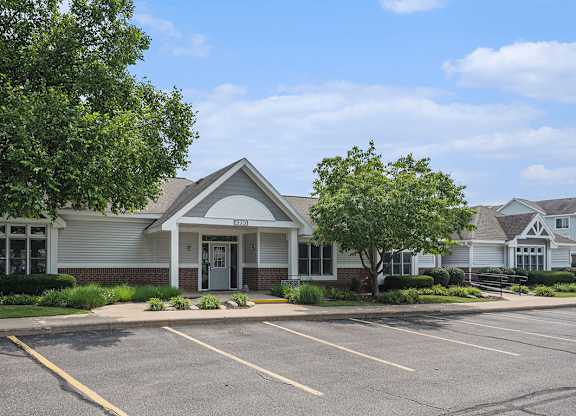 A leasing office with a parking lot in front of it at Gull Prairie/Gull Run Apartments and Townhomes, Kalamazoo