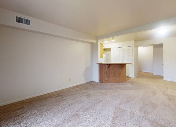 A living room with a carpeted floor at Gull Prairie/Gull Run Apartments and Townhomes, Kalamazoo, Michigan