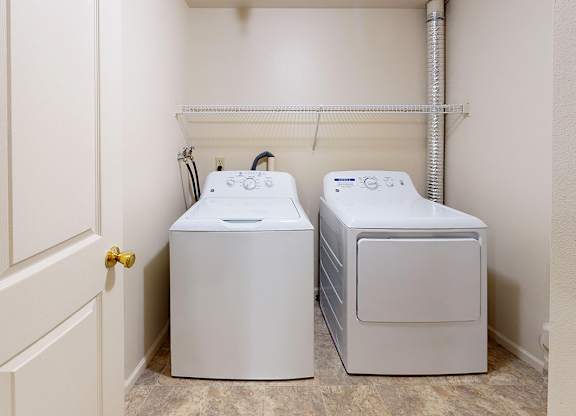 Laundry room with a washer and dryer in it at Gull Prairie/Gull Run Apartments and Townhomes, Kalamazoo, Michigan