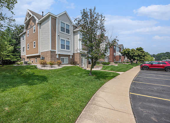 An apartment building with off street parking in front of it at Gull Prairie/Gull Run Apartments and Townhomes, Kalamazoo, Michigan