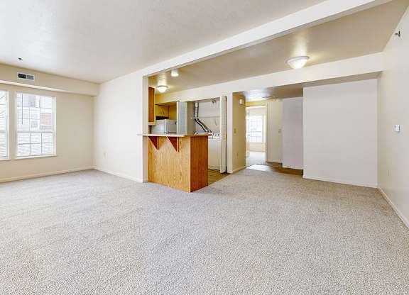 A spacious living room with a carpeted floor at Gull Prairie/Gull Run Apartments and Townhomes, Kalamazoo, 49048