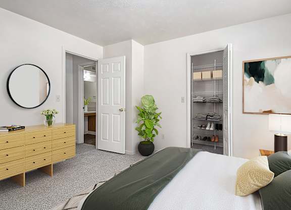 A bedroom with a bed, dresser, and a walk-in closet at Gull Prairie/Gull Run Apartments and Townhomes, Michigan, 49048