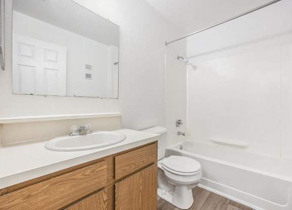 a bathroom with a sink toilet and a bath tub at Hampton Lakes Apartments, Michigan, 49534