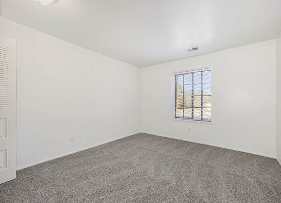 spacious bedroom with a window at Hampton Lakes Apartments, Michigan, 49534