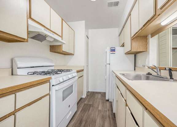 a kitchen with a gas stove, dishwasher, and a refrigerator at Hampton Lakes Apartments, Michigan, 49534