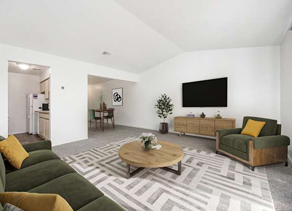 a living room with a vaulted ceiling,  couch and a coffee table at Hampton Lakes Apartments, Michigan, 49534
