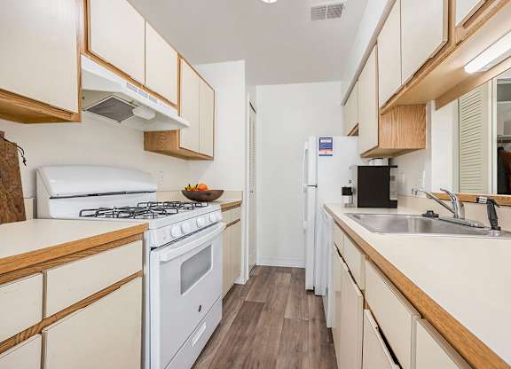 a kitchen with dishwasher and gas stove at Hampton Lakes Apartments, Michigan, 49534