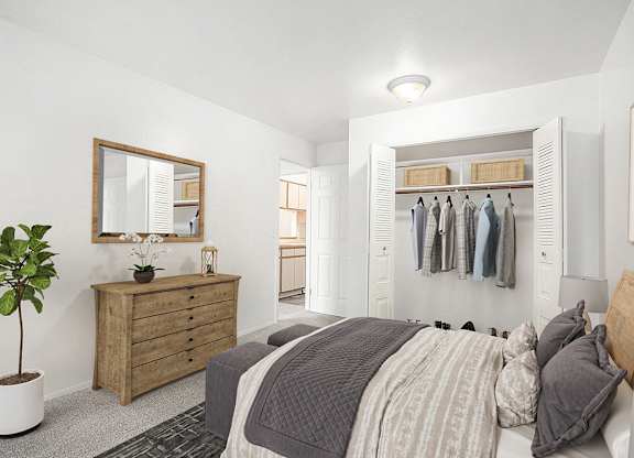 A bedroom with a bed, dresser, mirror and a closet at Hampton Lakes Apartments, Michigan, 49534