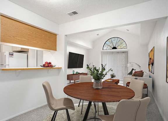 A dining room leading to a living room with a cathedral ceiling at Hampton Lakes Apartments, Michigan, 49534