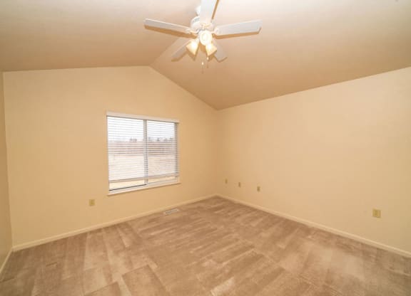 Bedroom with a Ceiling Fan at Foxwood and The Hermitage, Portage, MI