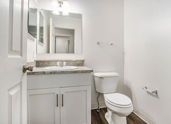A white toilet sits in a bathroom next to a sink at Foxwood and The Hermitage, Portage, MI, 49024