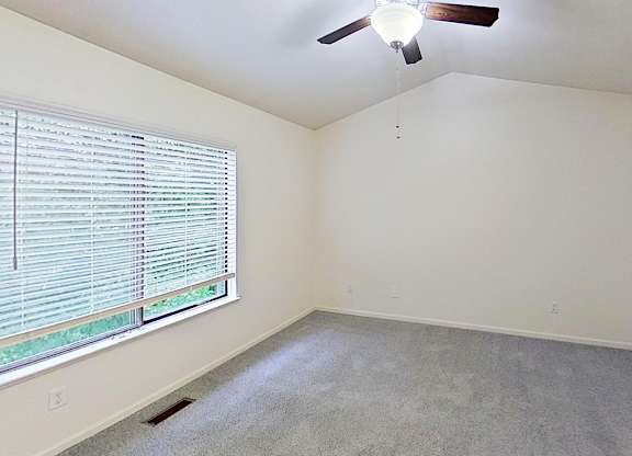 Master bedroom with a cathedral ceiling and ceiling Fan at Foxwood and The Hermitage, Portage, MI