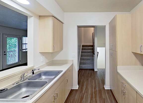 A kitchen with a microwave, stove and a sink at Foxwood and The Hermitage, Portage, MI, 49024