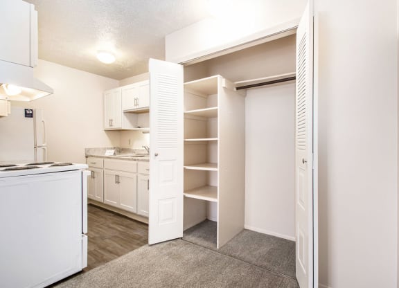a kitchen with white cabinets and a white stove top oven at Hickory Village Apartments, Indiana