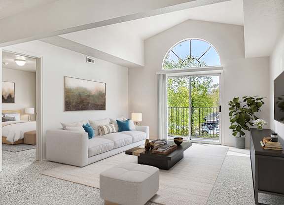 A living room with a cathedral ceiling at The Highlands Apartments in Elkhart, IN