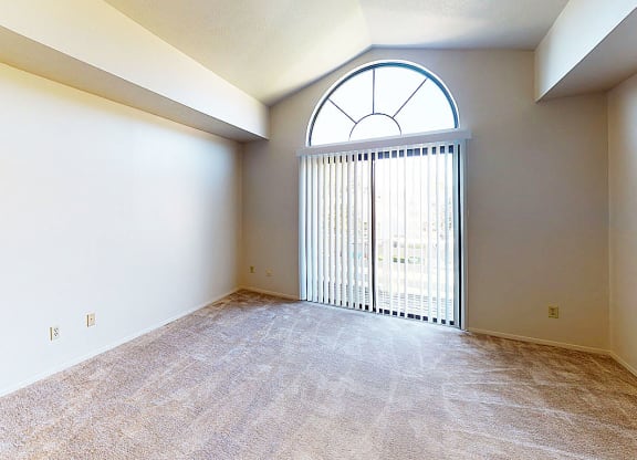 living room with a large window and a cathedral ceiling at Hurwich Farms Apartments, Indiana