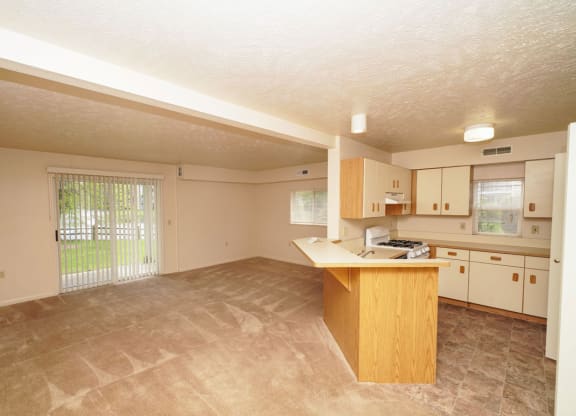 End style kitchen and living room leading to a private patio at Hurwich Farms Apartments, Indiana