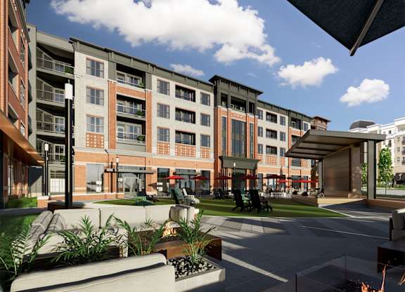 Courtyard with lounge chairs and modern pavilion structure at Icon on Main Apartments, Carmel, IN 46032