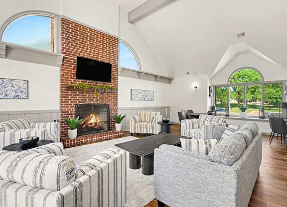 A community building with a fireplace and a flat screen TV mounted on the wall at Indian Lakes Apartments, Mishawaka, Indiana