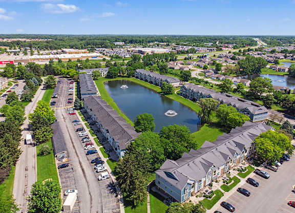 A large pond is surrounded by apartment buildings at Indian Lakes Apartments, Mishawaka, Indiana