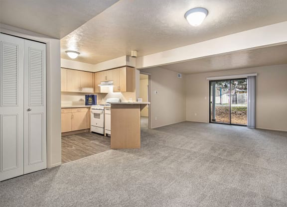 Two bedroom one bath living room with a door to patio at Indian Lakes Apartments, Mishawaka, 46545