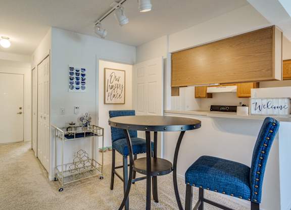 A dining area with a table and chairs  at Northport Apartments, Macomb, MI, 48044
