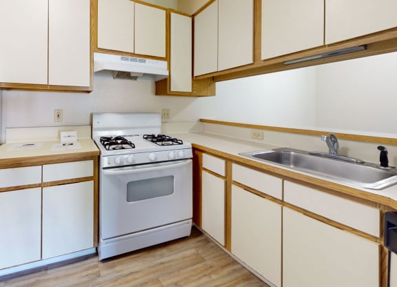 One bedroom seville kitchen with white appliances and breakfast bar at Irish Hills Apartments, South Bend, IN, 46614