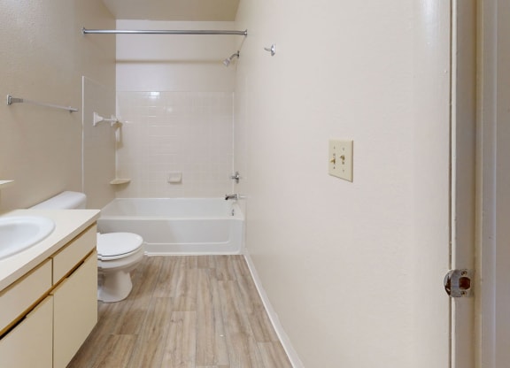 a seville bathroom with a large vanity and a shower/bath tub combination at Irish Hills Apartments, South Bend, IN, 46614