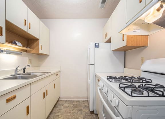 a kitchen with white appliances at Irish Hills Apartments, Indiana