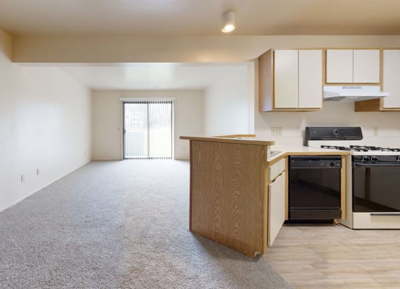 Open living room and kitchen with a breakfast bar at Irish Hills Apartments, Indiana, 46614