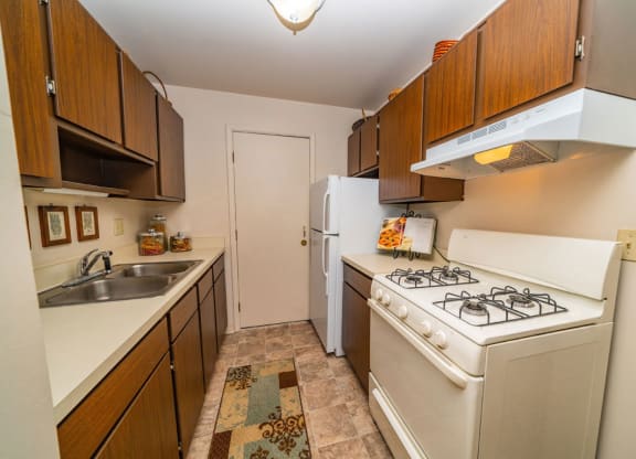 a kitchen with a stove and a refrigerator at Irish Hills Apartments, South Bend, Indiana