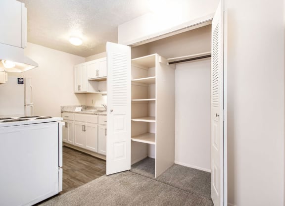 a renovated kitchen with white appliances and a closet at Irish Hills Apartments, South Bend, IN, 46614