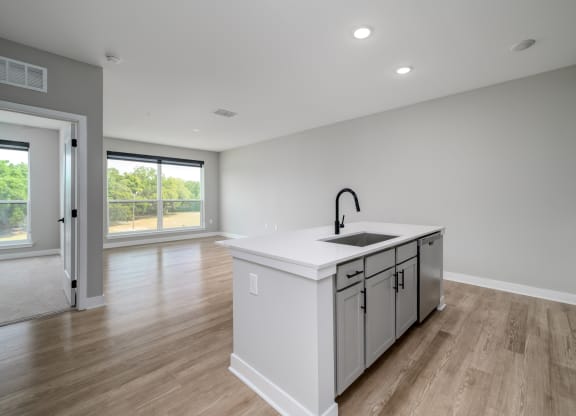 a large white kitchen with a large island in the middle at Ironwood Flats in Brandon, FL 33511