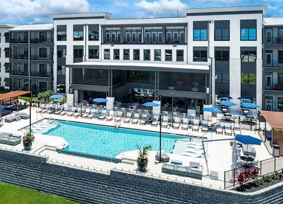 A large building with a pool in front at Ironwood Flats Apartments, Brandon, Florida