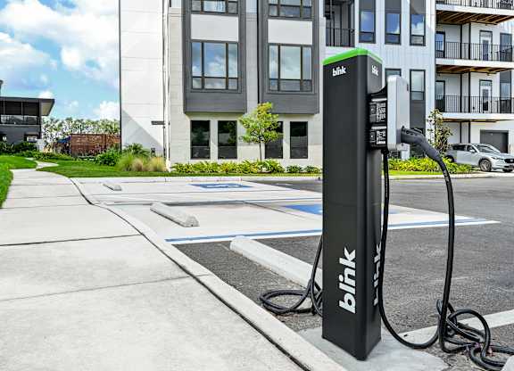 A black charging station with the word at Ironwood Flats Apartments, Brandon, FL, 33511